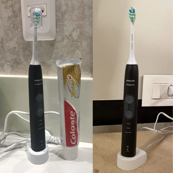 Philips Colgate SonicPro 50 sobre base de carregamento, ao lado de creme dental Colgate Total 12